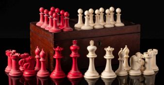 A Staunton pattern bone chess set: one side stained red, the other left natural, the king 9cm.