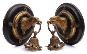 A pair of late 19th century gilt brass wall light fittings: in the form of eagle heads with