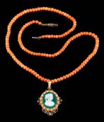A green and white agate layered cameo portrait pendant: depicting a young woman in profile within a