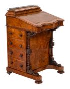 A Victorian walnut and inlaid serpentine fronted Davenport:,