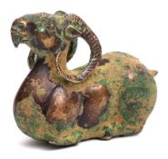 A gilt bronze model of a recumbent ram: with raised head, 11cm. long.