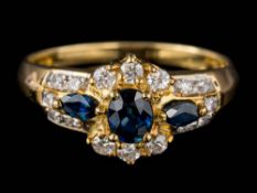 A sapphire and diamond cluster ring: set with oval and marquise-shaped sapphires and round,
