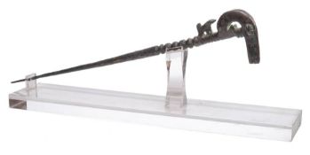 A Persian cast metal pin: with stylised ram's head terminal with knopped and tapering spike, 35cm.