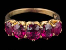 A graduated ruby five-stone ring: the oval rubies graduate from approximately 5mm long to 6mm long,