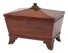 A William IV mahogany sarcophagus-shaped cellarette: the hinged top with carved acanthus and fruit