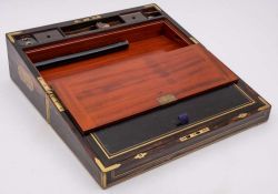 A Victorian coromandel and brass bound and strung writing box: the hinged lid enclosing a leather