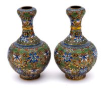 A pair of Chinese champleve enamel garlic-mouth bottle vases: each decorated with a raised design