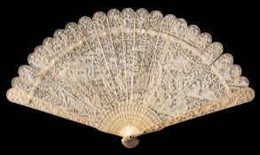 A late 19th century Cantonese carved ivory brise fan: decorated to one side with figures in a