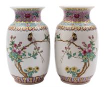 A pair of Chinese famille rose vases: each painted with an inscription and a long tailed bird