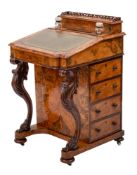 A Victorian walnut and inlaid Davenport:, of bowed breakfront outline,