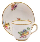 A Sèvres cup and saucer: painted with floral sprays within gilt dentil borders,