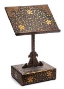 A Japanese gold lacquer book stand: in three sections, decorated overall with scrolling prunus,