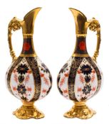 A pair of Royal Crown Derby ewers: in the 'Old Imari' pattern with solid gold borders,