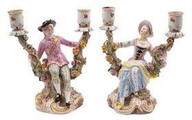 A pair of Meissen two-branch figural candelabra: in the form of a gallant and lady in 18th century