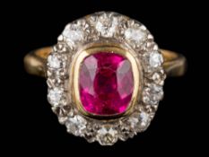 A synthetic ruby and diamond cushion-shaped cluster ring: the cushion-shaped synthetic ruby