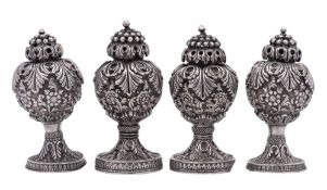 A set of four Indian white metal pepperettes,
