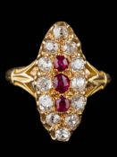 A ruby and diamond marquise-shaped cluster ring: centring three oval rubies within a surround of