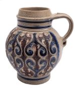 A German Westerwald stoneware jug: moulded and painted in blue and manganese with a repeated design