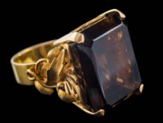 A rectangular smoky quartz, single-stone dress ring: with foliate shoulders, approximately 16.