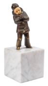 An Art Deco bronze and ivory figure of a young boy: dressed in a clown's suit, lighting a cigarette,