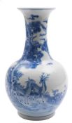 A Chinese blue and white bottle vase: painted with deer in a landscape with a large pine tree,