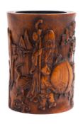 A Chinese 'Shoulao' bamboo brush pot: carved with Shoulao resting one hand on a giant peach