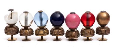 A group of seven Chinese Mandarin hat finials: the different coloured glass balls mounted on gilt