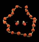 A carved coral bead,