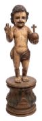 A polychrome wood figure of St John The Baptist as a boy: semi robed holding an orb in his left