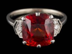 A cushion-shaped hessonite garnet and diamond ring: the hessonite garnet approximately 11.