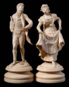 A pair of Continental carved ivory figures,
