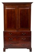 A 19th Century mahogany linen press:, the upper part with a moulded dentil cornice,