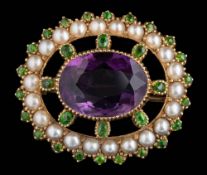 An amethyst, seed pearl and demantoid garnet-set oval brooch: approximately 25mm overall length, 5.
