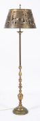 An 20th century brass hunting theme standard lamp: the circular brass shade with piecework and
