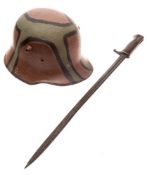 A WWI German M16 pattern steel helmet: stamped 'BF84' to inner, later over painted camouflage,