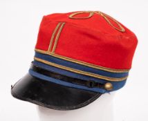 A French red and blue cloth Kepi: with gilt braid line to sides and knot to top, black leather peak,