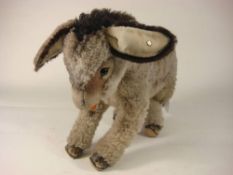 A mid 20th century grey plush Steiff donkey: with button to one ear, black button eyes,