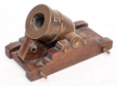 A late 19th century brass and oak model of a mortar:,