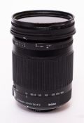 A Sigma 18-300mm f3.5-f6.3 DC macro lens in original box and bag.
