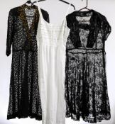 A mid 20th century black lace over dress and one other similar,