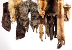 A collection of various mid to late 20th century fur stoles and hats.