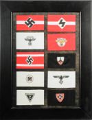A framed collection of reproduction German army armbands: