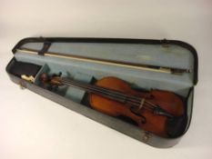 A Czechoslovakian violin: scroll carved headstock over ebony finger board and body with two piece