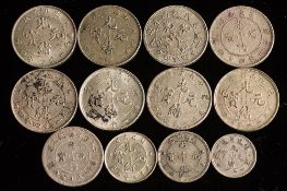 Twelve silver Chinese coins.