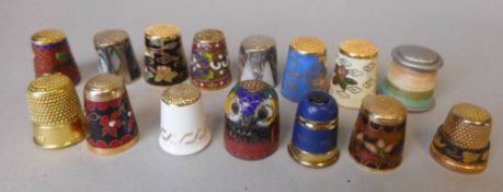 A collection of sewing thimbles: most with cloisonne enamel decoration,