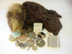 A Harrods fur stole, two other furs and a collection of mid 20th century powder compacts.
