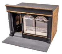 A wooden scale model of an Edwardian dress shop: the black glazed facade with fitted interior