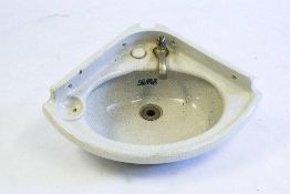 A LMS cabin earthenware corner sink: with short splashback and single tap,