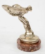 A Rolls-Royce Spirit of Ecstasy radiator mascot, mounted on a marble socle, 15cm high.