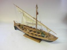 A scale model of a whaling boat: running rigged over detailed decks with oars,